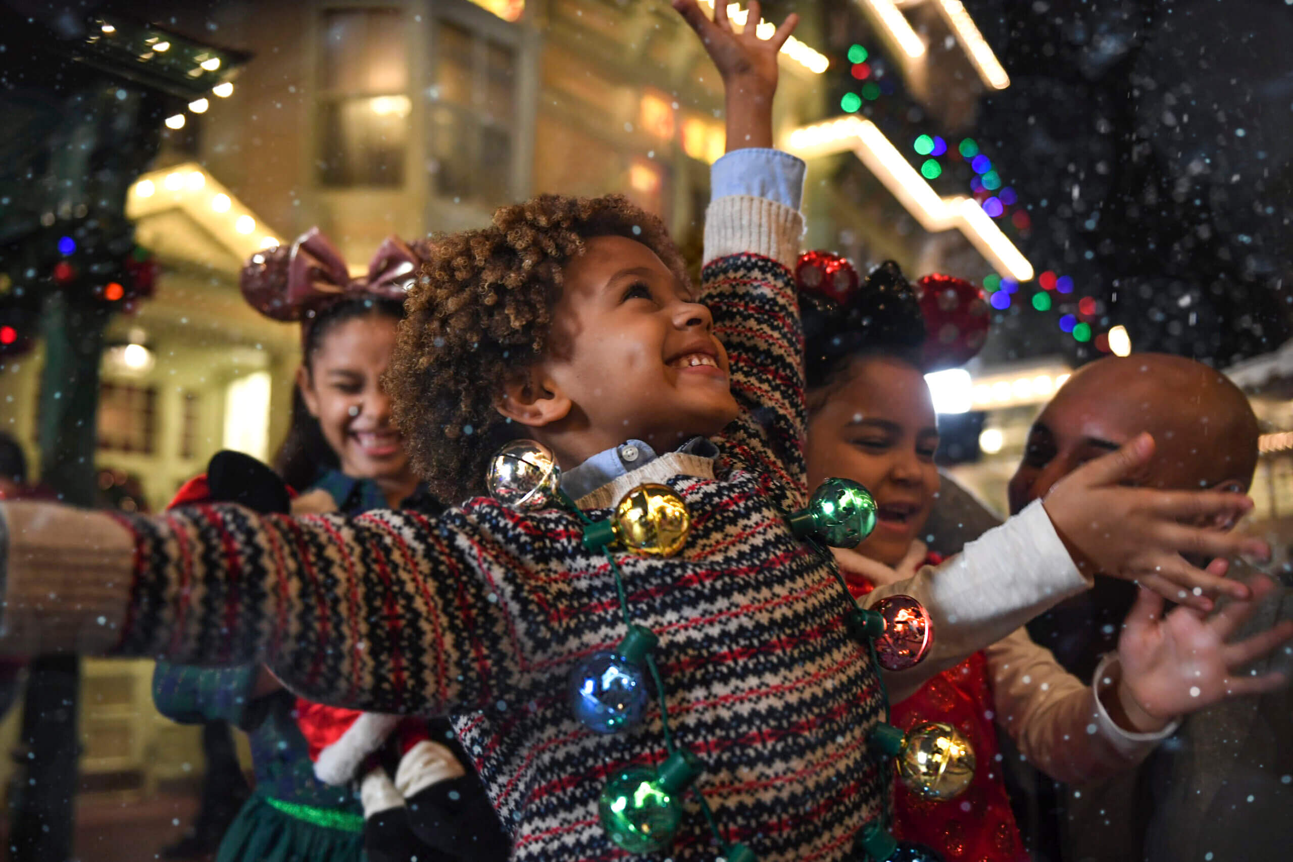 Little kids playing in the "snow" at Disney