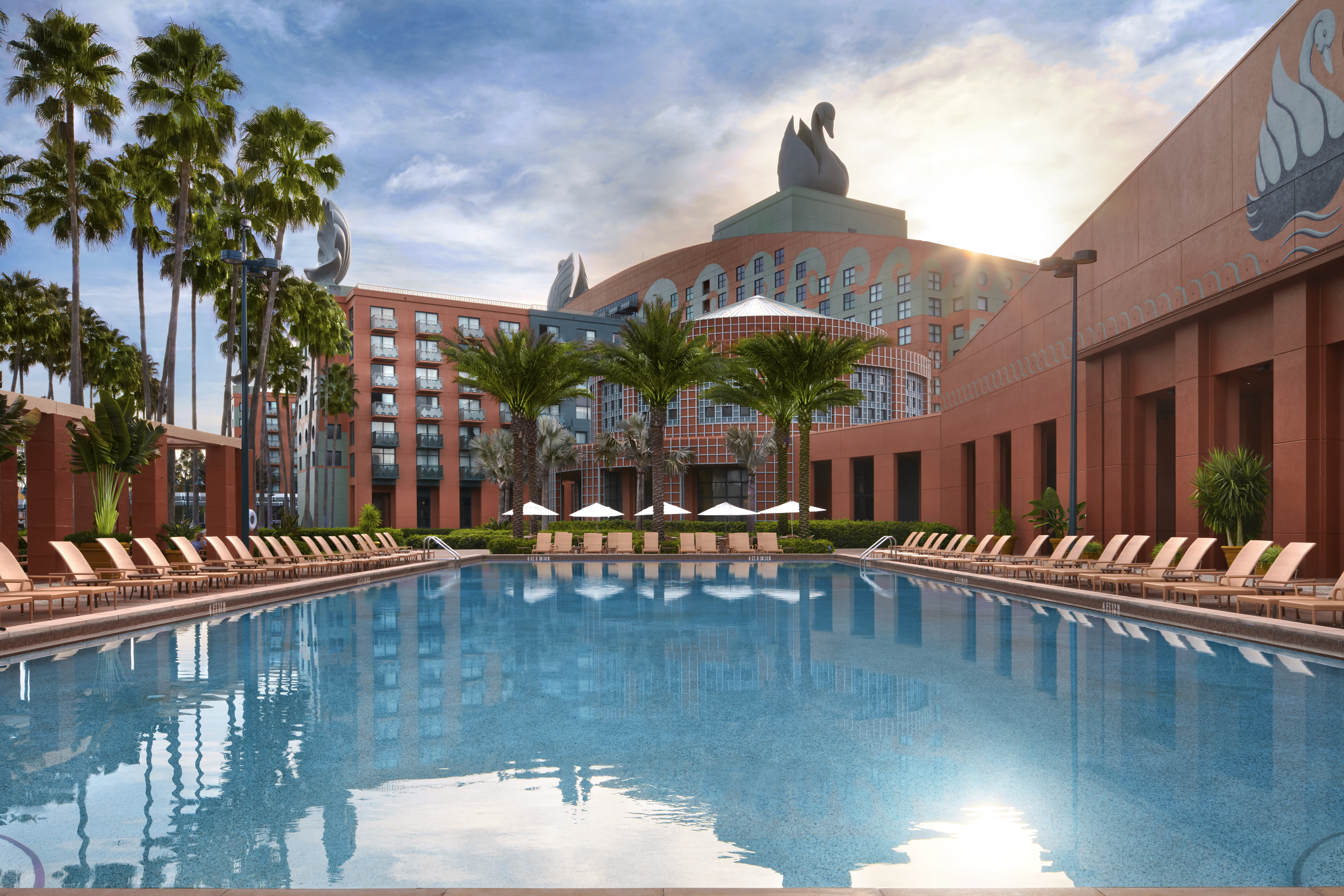Swan Pool with Chairs, Umbrellas, Palm Trees and Hotel View