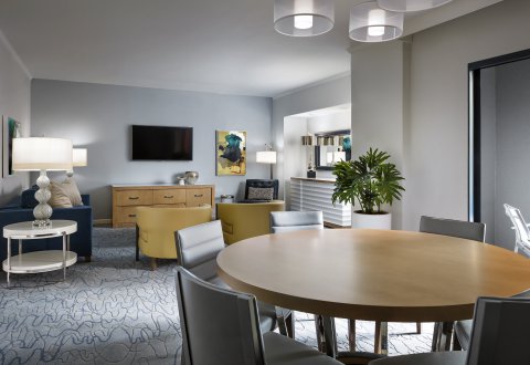 Swan Executive Suite Sitting Area with with Table, Chairs, Couch and Large TV