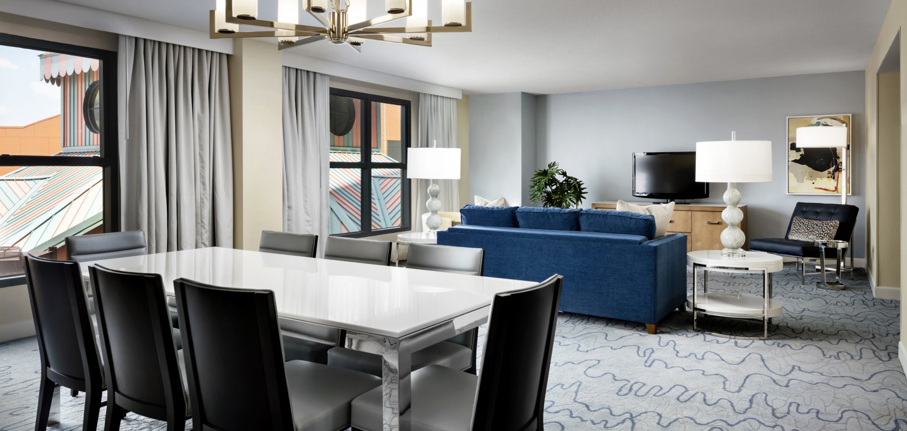 Dolphin Grand Suite Dining Room with Tables, Couch, Chairs and Large TV