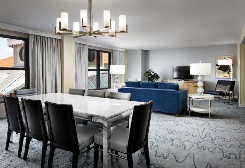 Dolphin Grand Suite Dining Room with Tables, Couch, Chairs and Large TV
