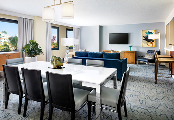 Dolphin Grand Suite Parlor with Tables, Chairs, Couch and a Large TV